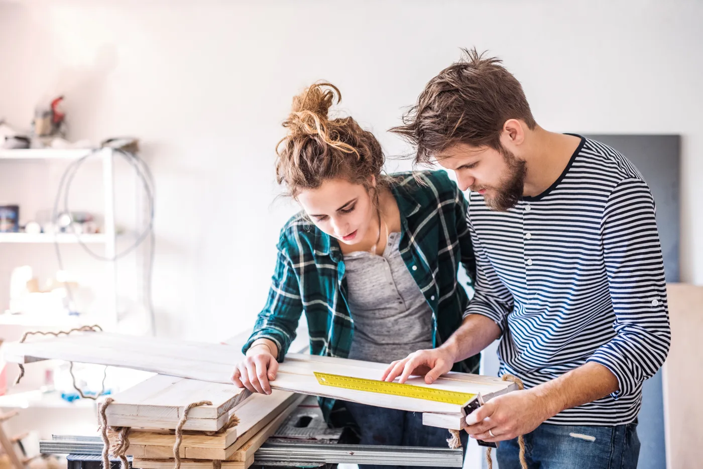 A small business couple measuring materials together in their studio